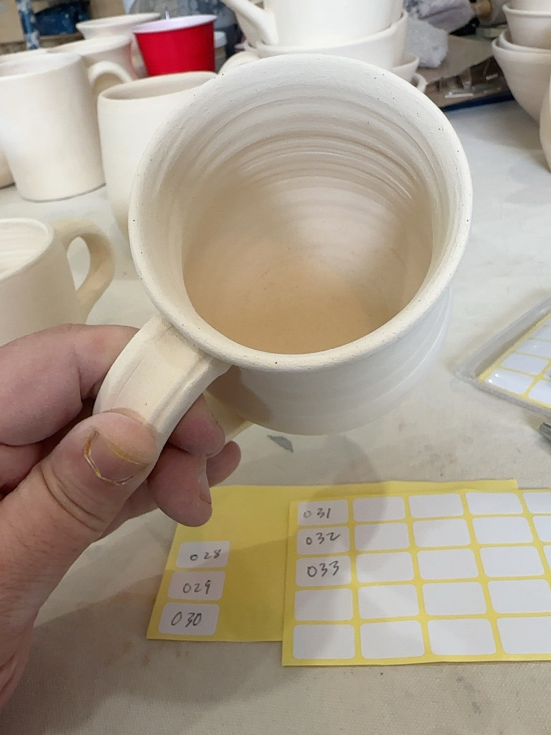 Studio Piece 022 bisque mug interior and handle attachment