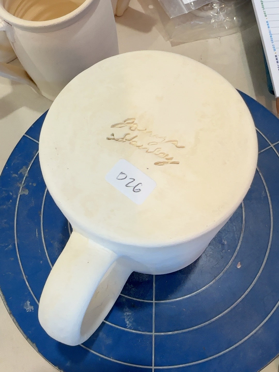 Studio Piece 026 mug base and maker stamp at bisque stage