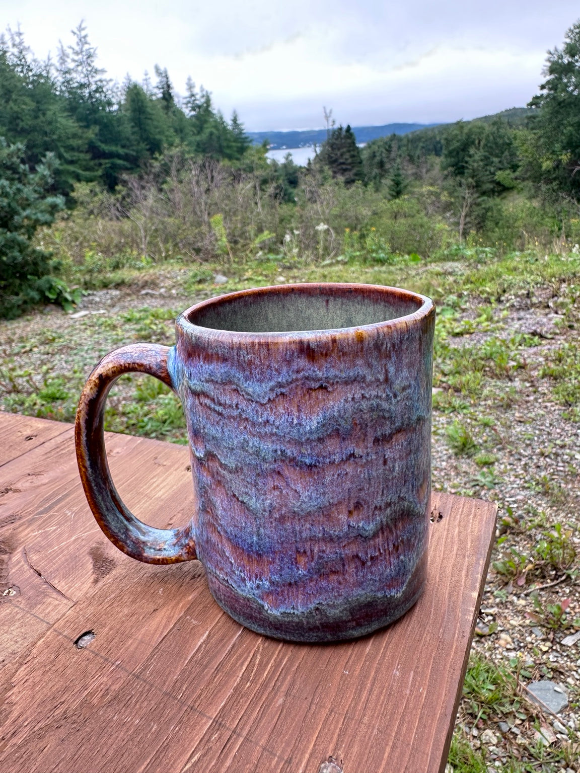 Studio Piece 026 fired mug outdoors, Iron Luster and Oatmeal glaze