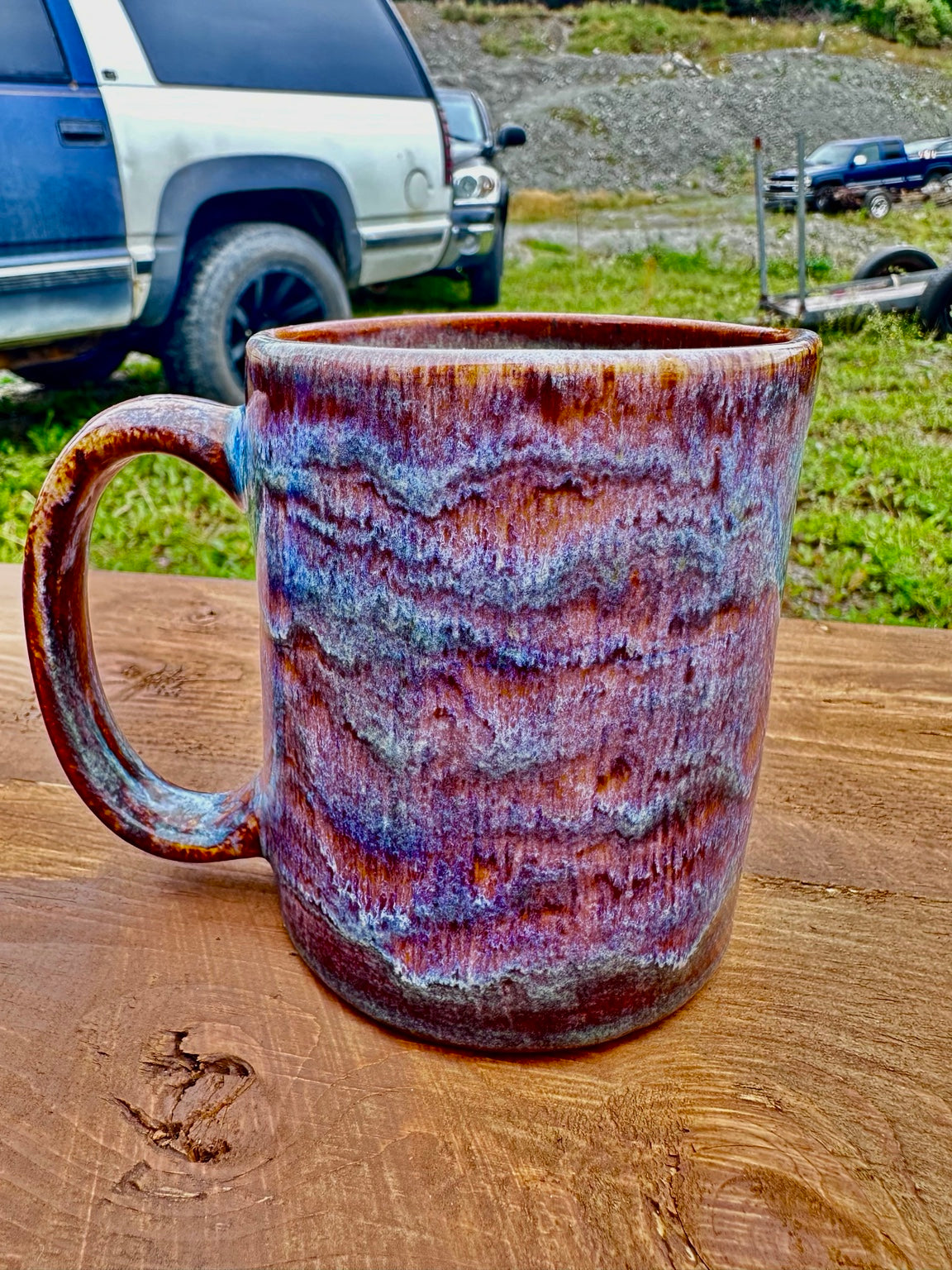 Studio Piece 026 fired mug outdoors, Iron Luster and Oatmeal glaze